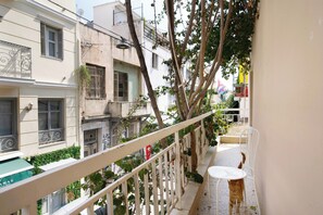 A narrow balcony with a white railing, a small table, and a chair. - Live in Athens, Psyrri Central Apartments (Athens)