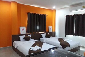 A hotel room with two beds, orange walls, and a large window with curtains. - GM Modern Place (Udon Thani)