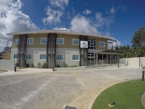 A modern hotel with a two-story structure, a covered entrance, and a well-maintained lawn. - Twin Tides Panglao (Panglao)
