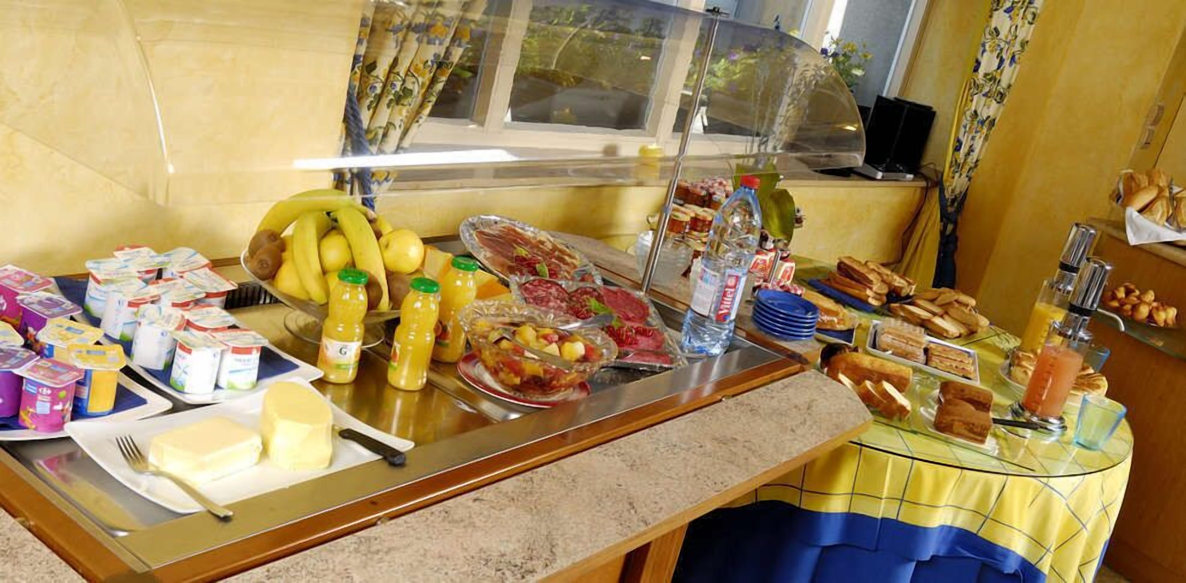 A breakfast buffet with various food items and beverages.