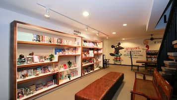 Cozy reading nook with bookshelves and a bench, surrounded by inspiring quotes.