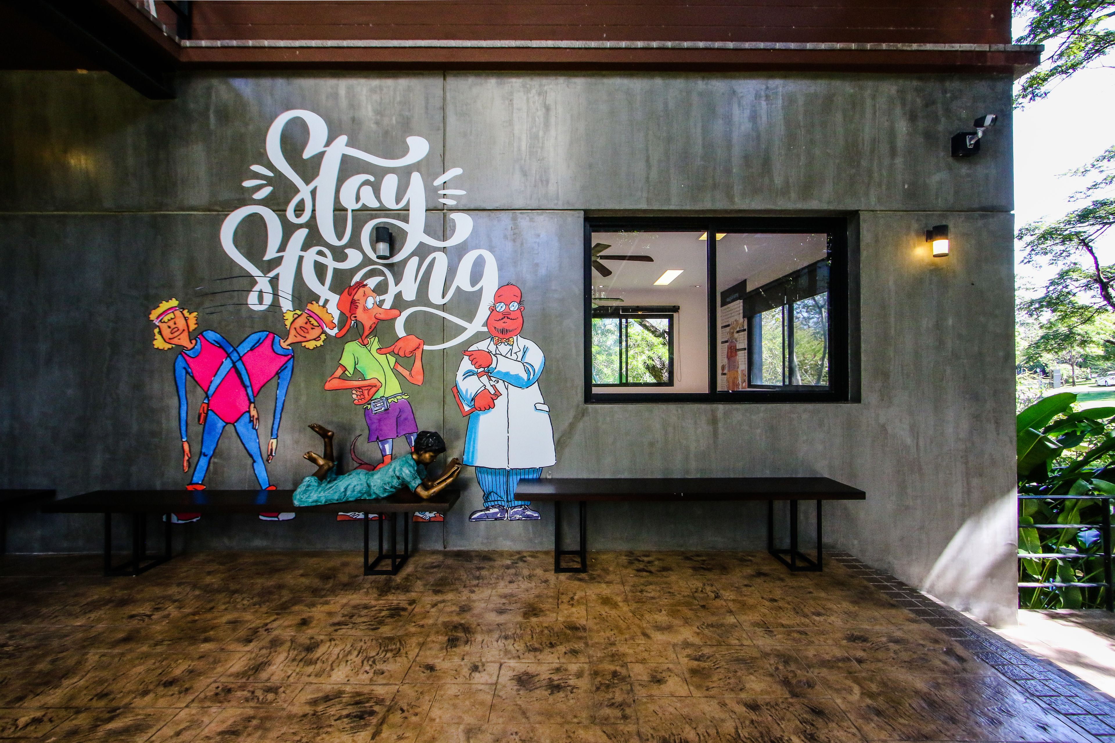 A mural with cartoon characters and the phrase "Stay Wrong" on a building wall.
