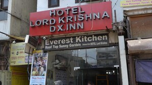 A hotel sign for 'HOTEL LORD KRISHNA DX.INN' and a restaurant named 'Everest Kitchen' with a sign for 'Roof Top Bunny Garden'. - Lord Krishna Hotel Dx. Inn (New Delhi)