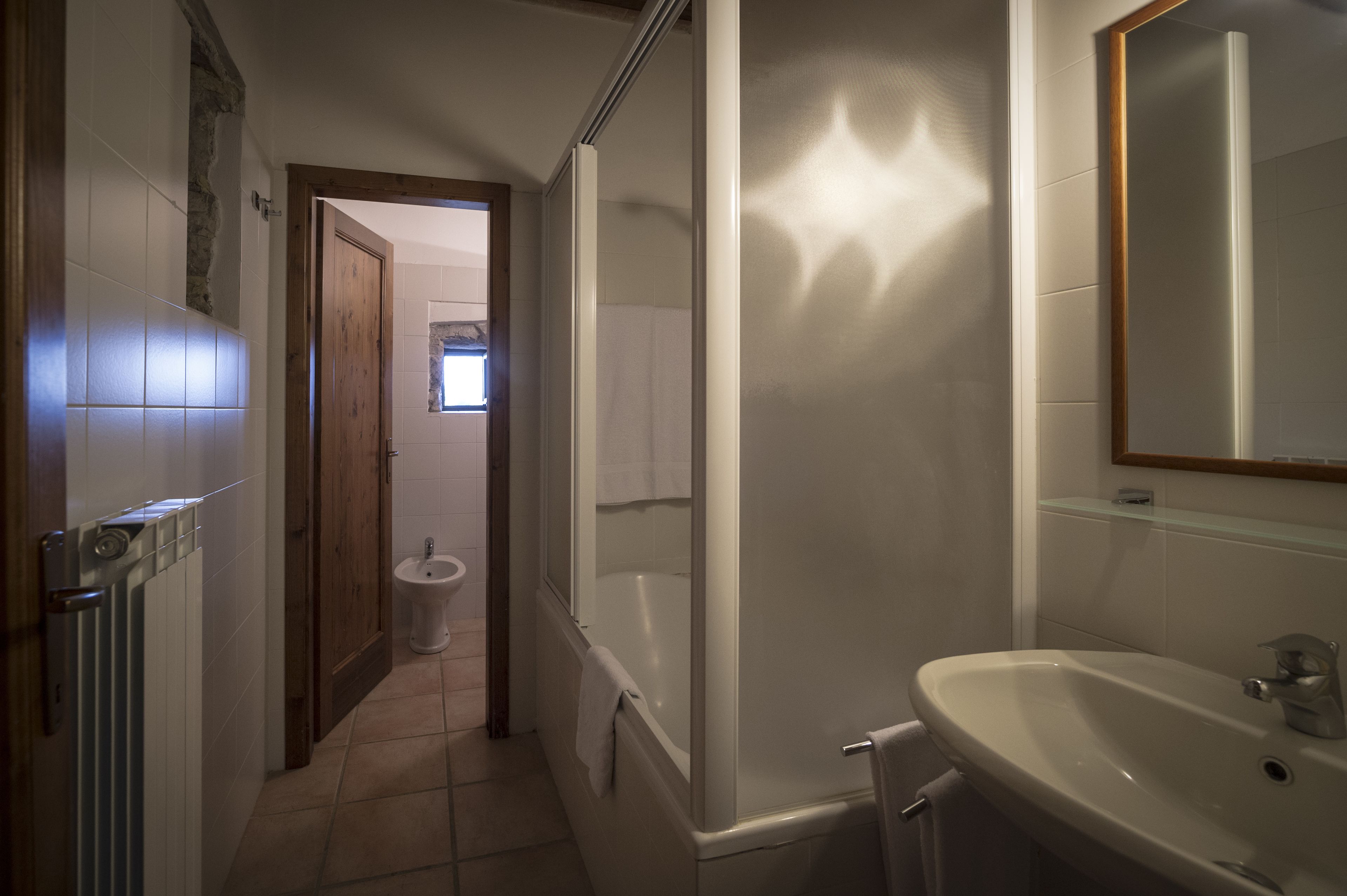 A bathroom with a bathtub, a sink, and a toilet.