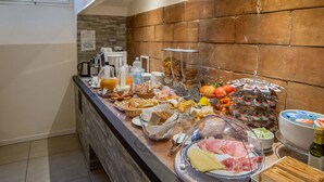 A buffet with various food items, including bread, cheese, and fruits. - Dimora Salviati (Florence)