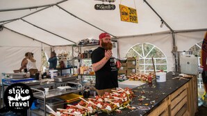 A tented food stall with a sign reading "Koltuz Mandoz" and "Just Food." - Zarautz Beachside Surf Camp (Zarautz)