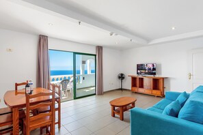 Deluxe Apartment, 2 Bedrooms, Ocean View | Living area | 24-inch flat-screen TV with satellite channels, LED TV - Club Tarahal (Puerto de la Cruz)
