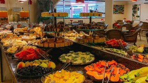 A buffet with various food items including fruits, vegetables, and desserts. - Pousada Angra Bella (Angra dos Reis)