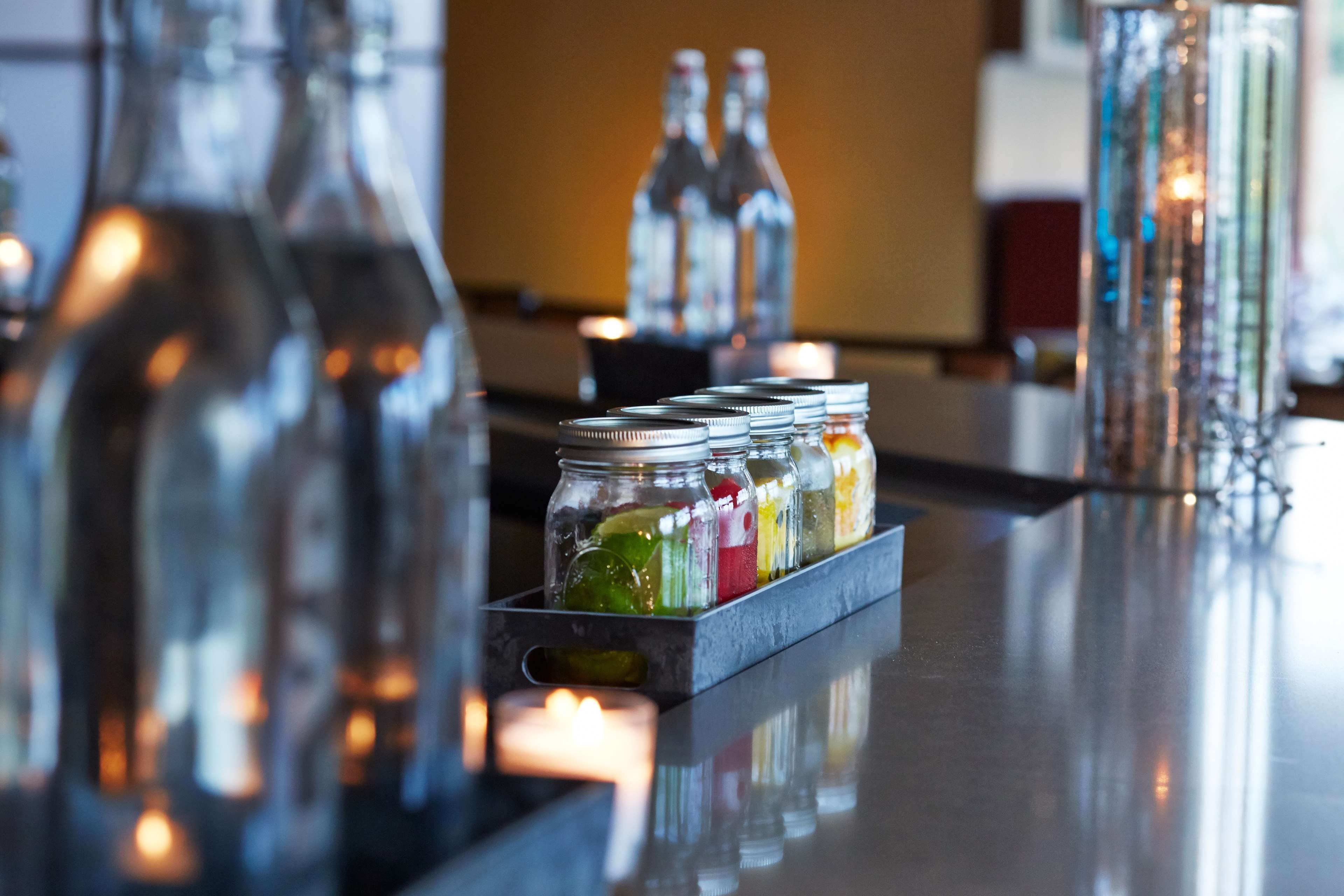 A bar area with bottles and a tray of colorful candies.
