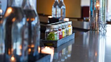A bar area with bottles and a tray of colorful candies.