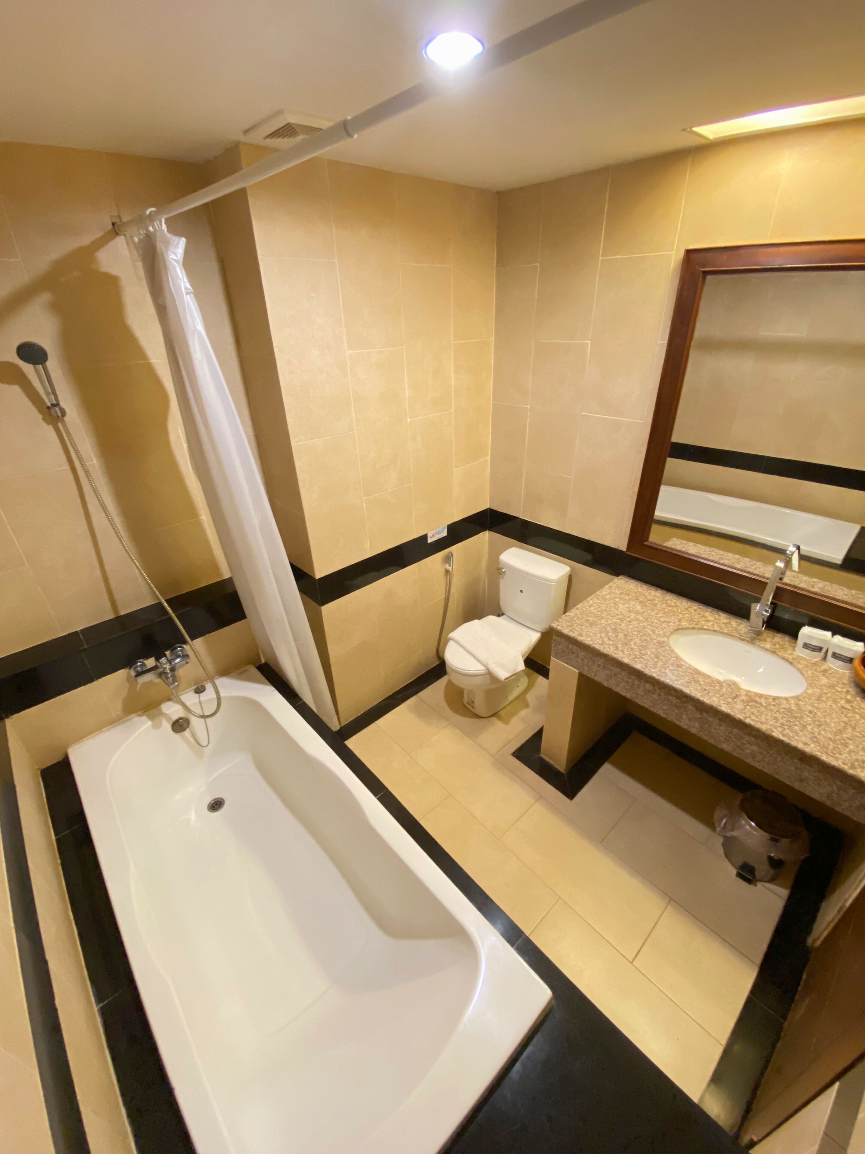 A bathroom with a bathtub, toilet, and sink.