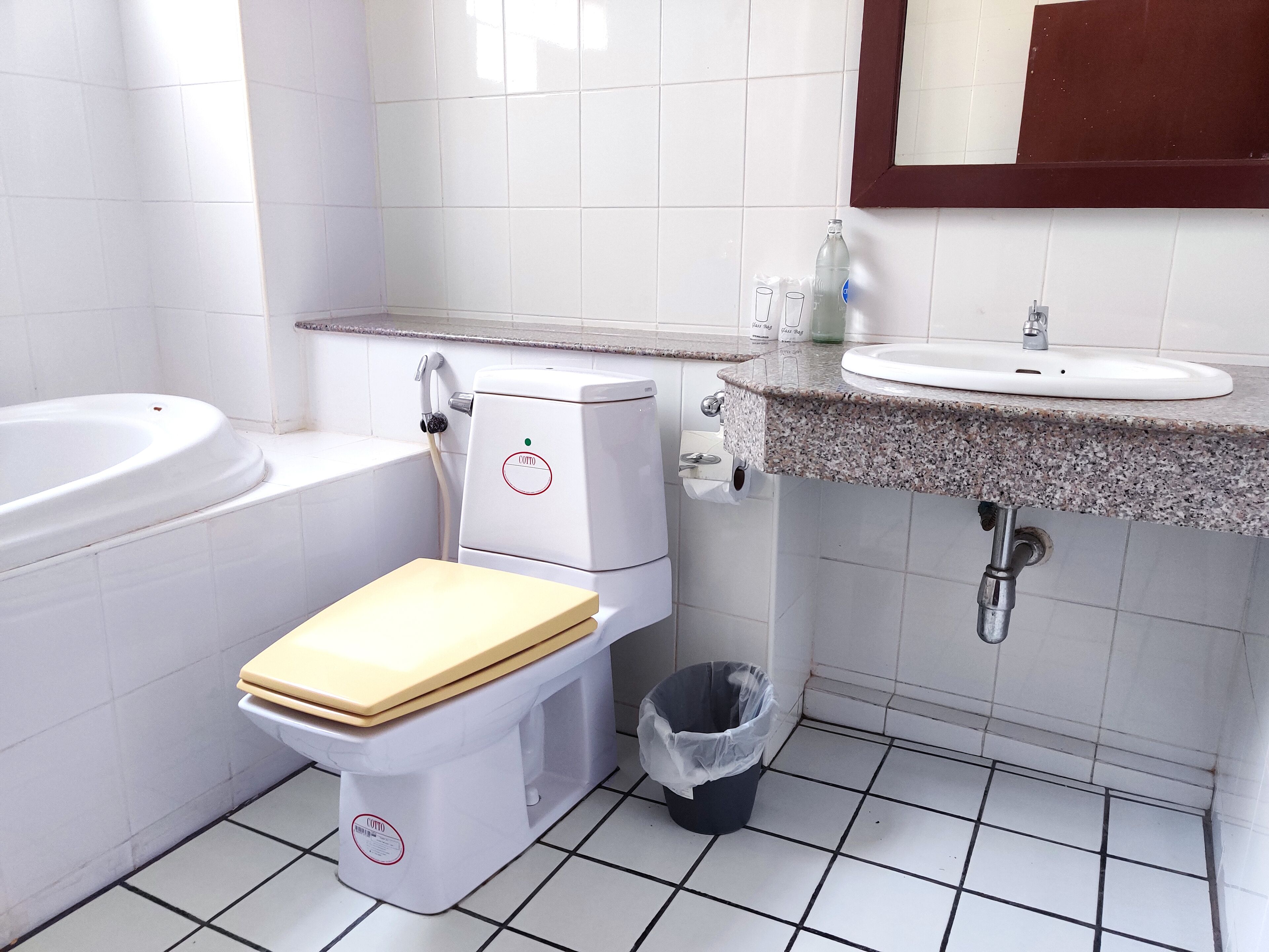 A bathroom with a toilet, bidet, and sink.