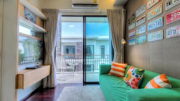 Modern 1 Bedroom Apartment | Living area | 40-inch flat-screen TV with cable channels, LCD TV, DVD player