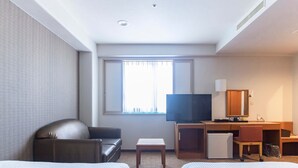 A hotel room with two beds, a desk, a television, and a window with curtains. - Hotel Wingport (Nagasaki)