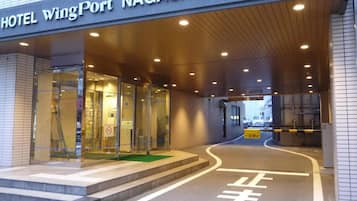 A hotel entrance with a sign reading 'HOTEL WingPort NAGASAKI'.