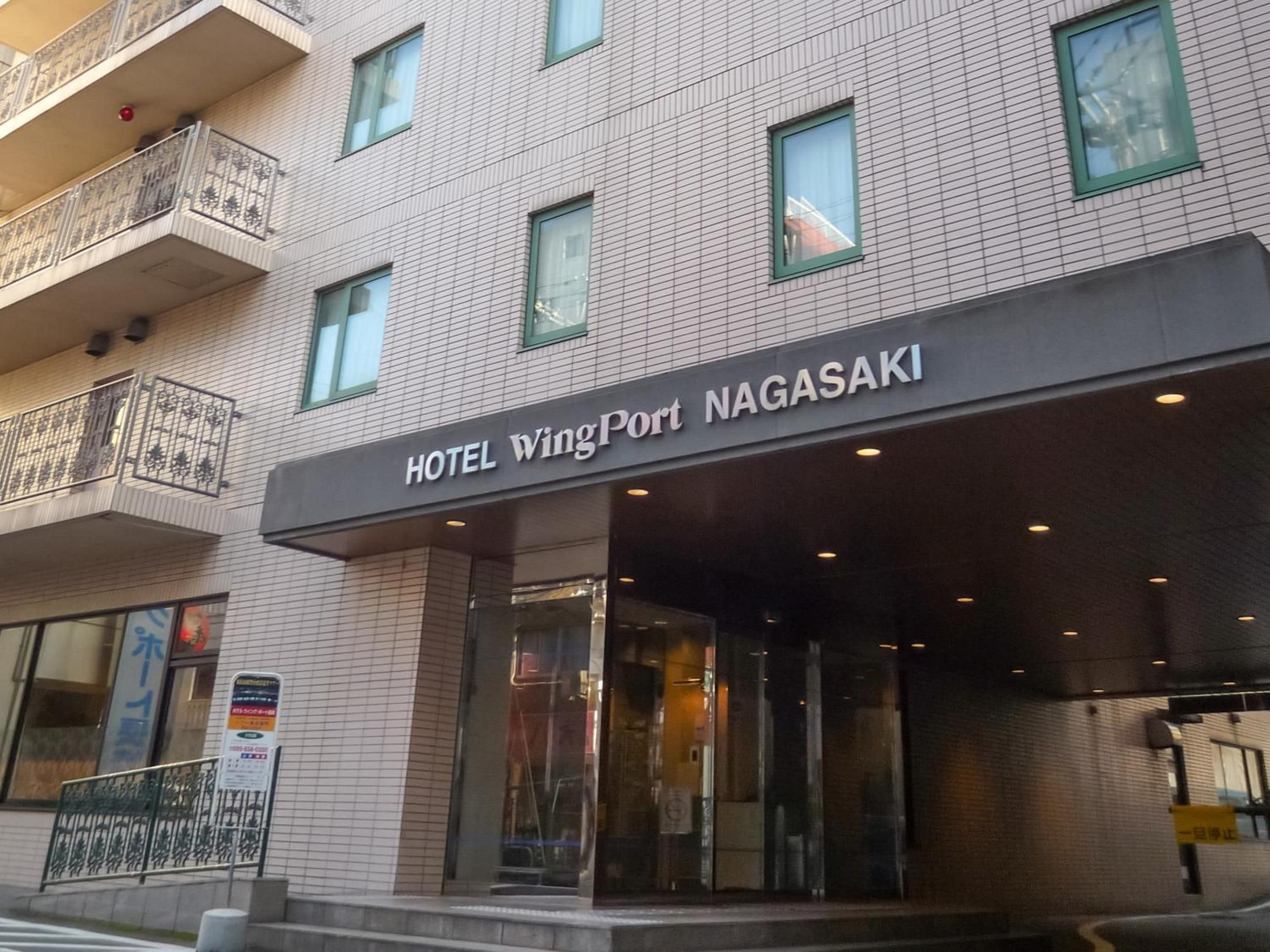 A hotel entrance with a sign reading 'HOTEL WingPort NAGASAKI.'