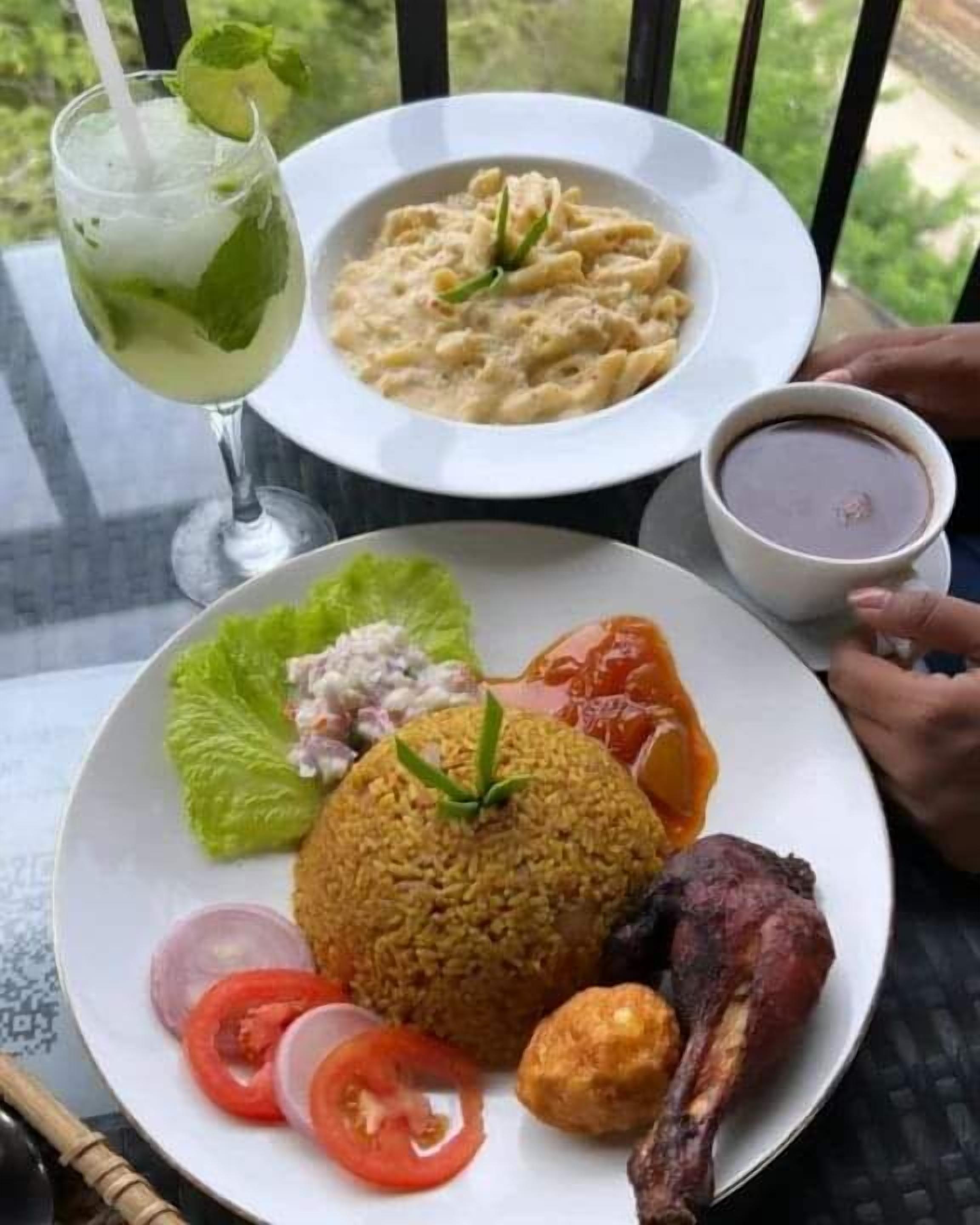 A meal consisting of rice, meat, and vegetables, served on a white plate.