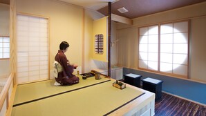 A traditional Japanese room with tatami flooring, a shoji screen, and a sliding door.