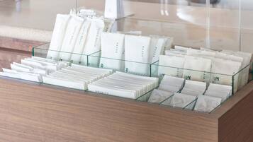 A display of toiletries in a hotel setting, including toothbrushes, razors, and hair care products.