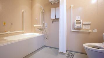 A bathroom with a bathtub, a shower, and a toilet.