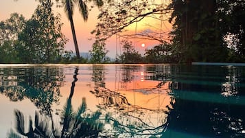 Outdoor pool, an infinity pool, pool loungers