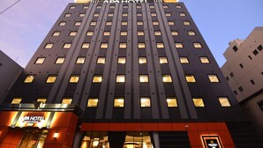 A tall building with the sign "APA HOTEL" at the top and entrance. - APA Hotel Kagoshima Tenmonkan (Kagoshima)