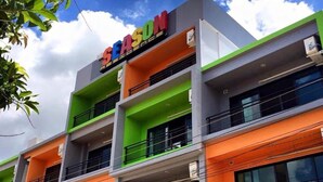 Un immeuble à plusieurs étages, sur lequel on peut voir une enseigne bien visible indiquant le mot « SEASON ».
