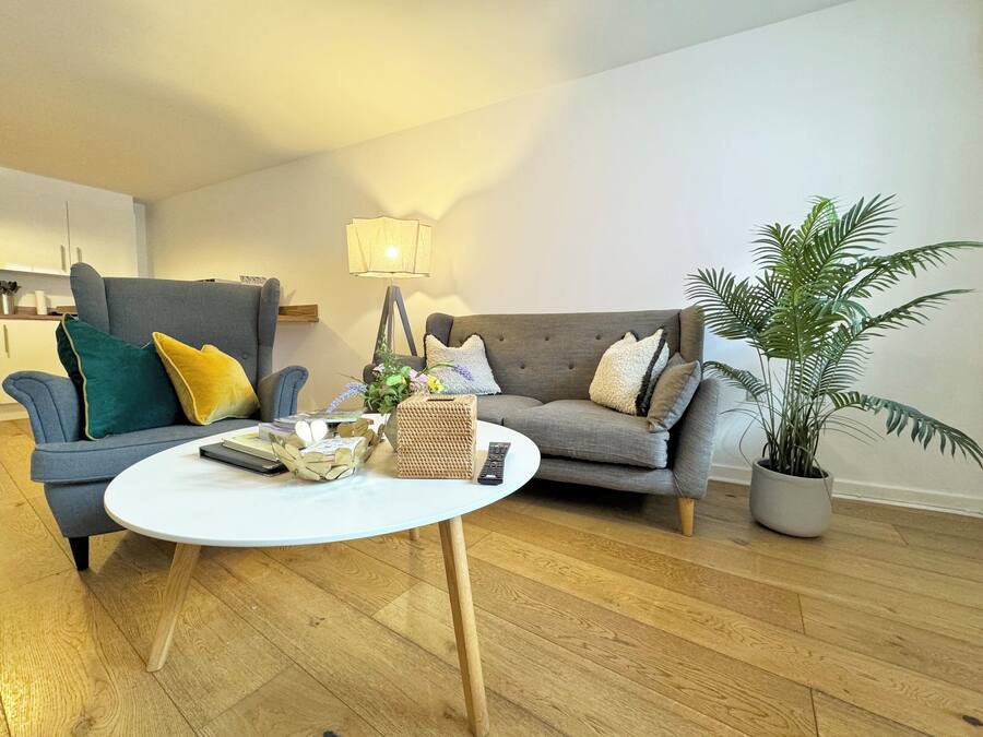En stue med to sofaer, et sofabord og en lampe.