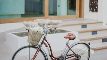 A bicycle parked in front of a building with a wooden facade and large windows.