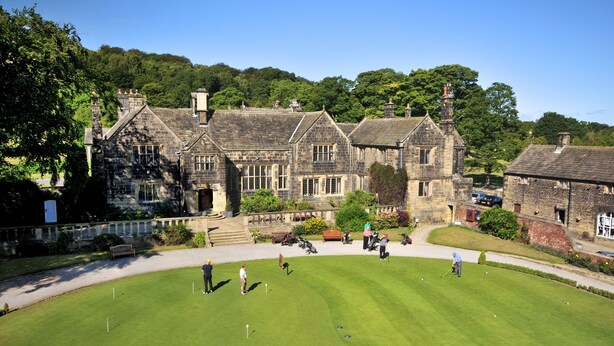 A golf course with a stone building in the background. - Woodsome Hall Golf Club Cottage on the Course (Huddersfield)