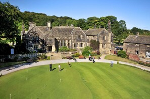 A golf course with a stone building in the background. - Woodsome Hall Golf Club Cottage on the Course (Huddersfield)