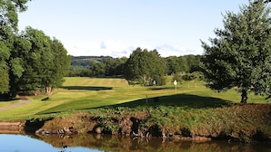 A golf course with a pond, trees, and a clear sky. - Woodsome Hall Golf Club Cottage on the Course (Huddersfield)