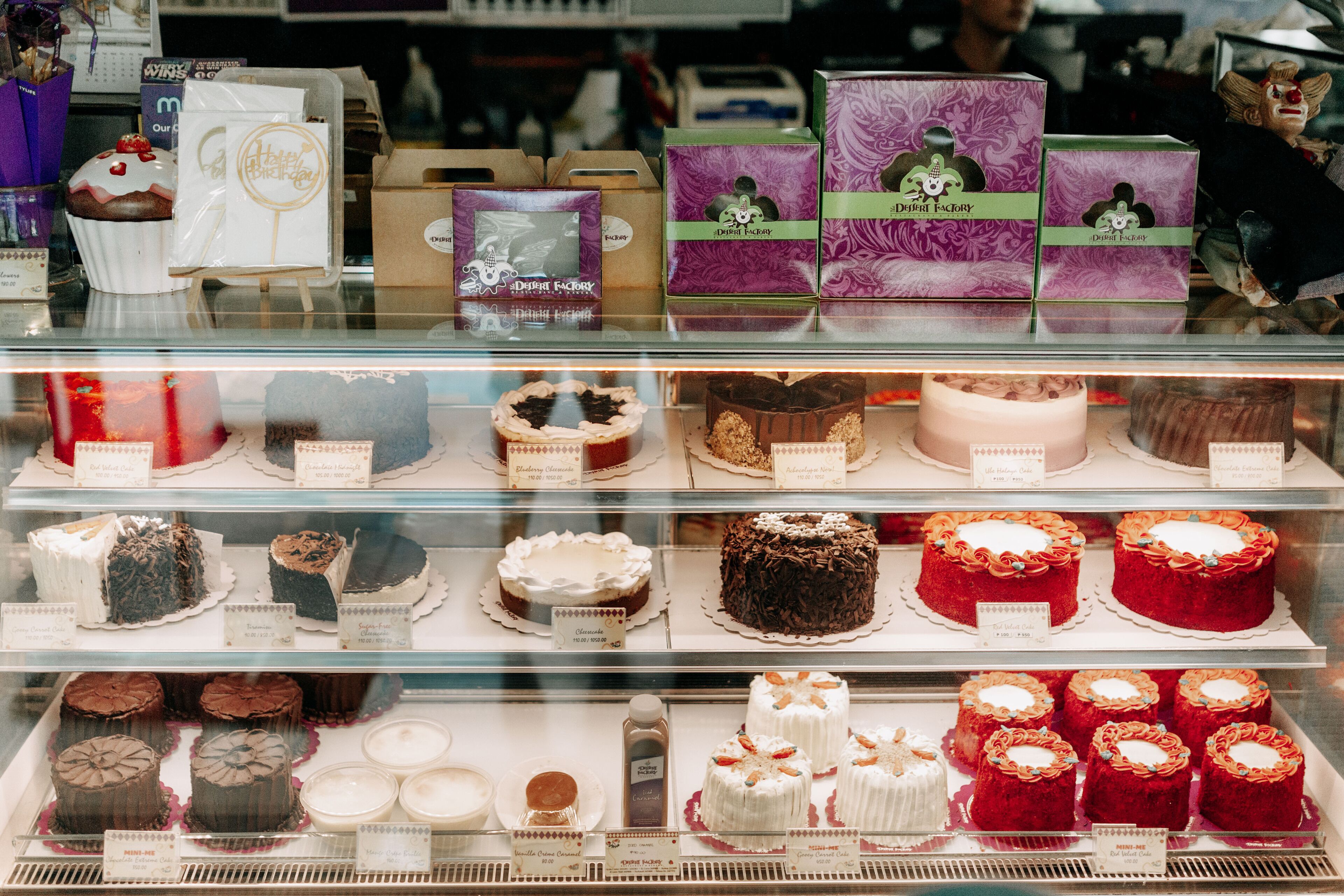 A bakery display with various cakes and pastries.