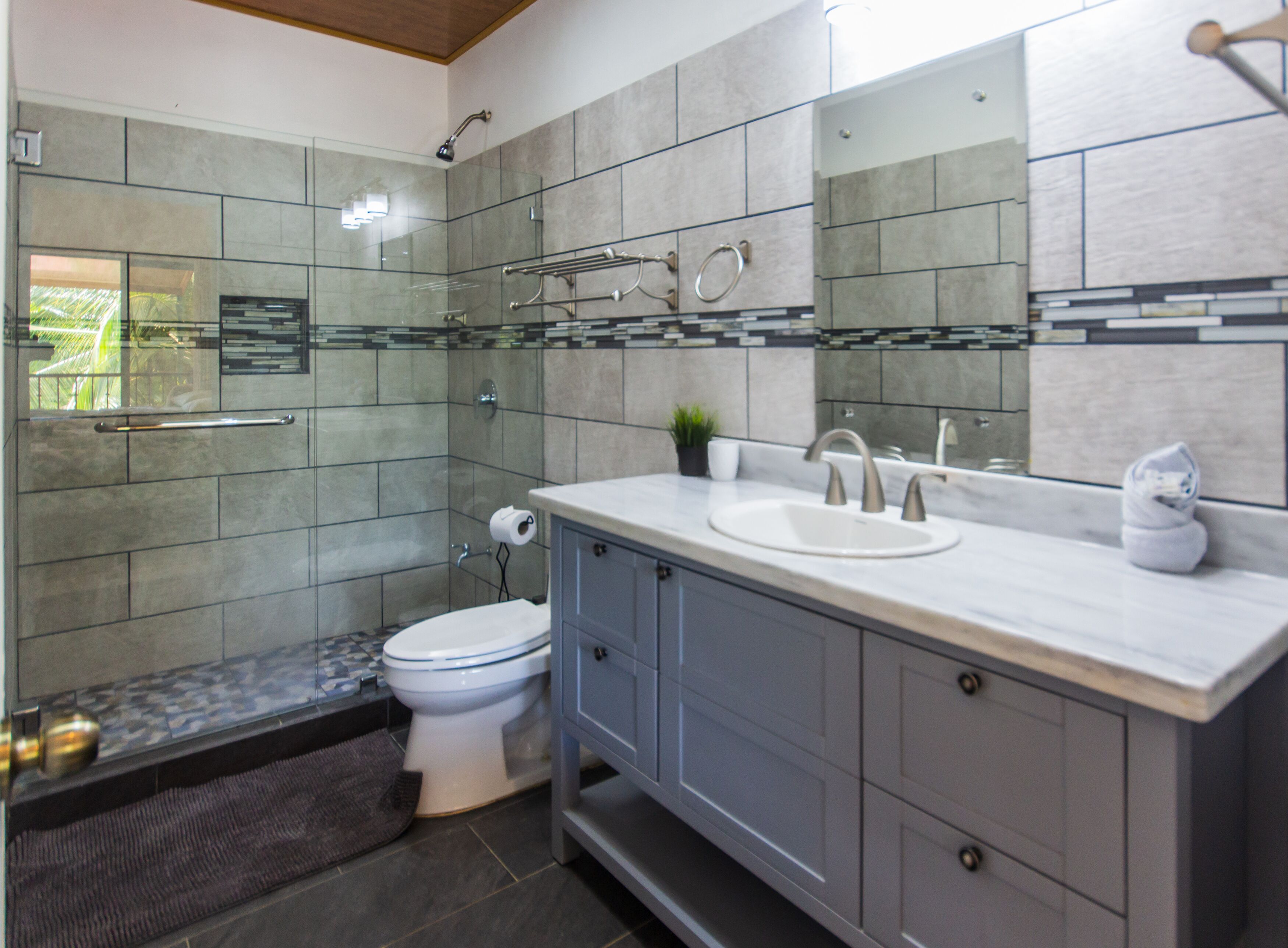 superior quadruple room | bathroom | rainfall showerhead, towels, soap, shampoo