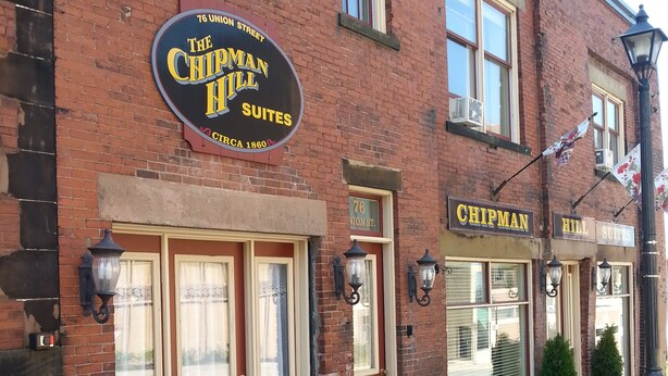A brick building with a sign for "The Chipman Hill Suites" and "Chipman Hill Suites" indicating a hotel or lodging establishment. - Chipman Hill Suites on Union (Saint John)