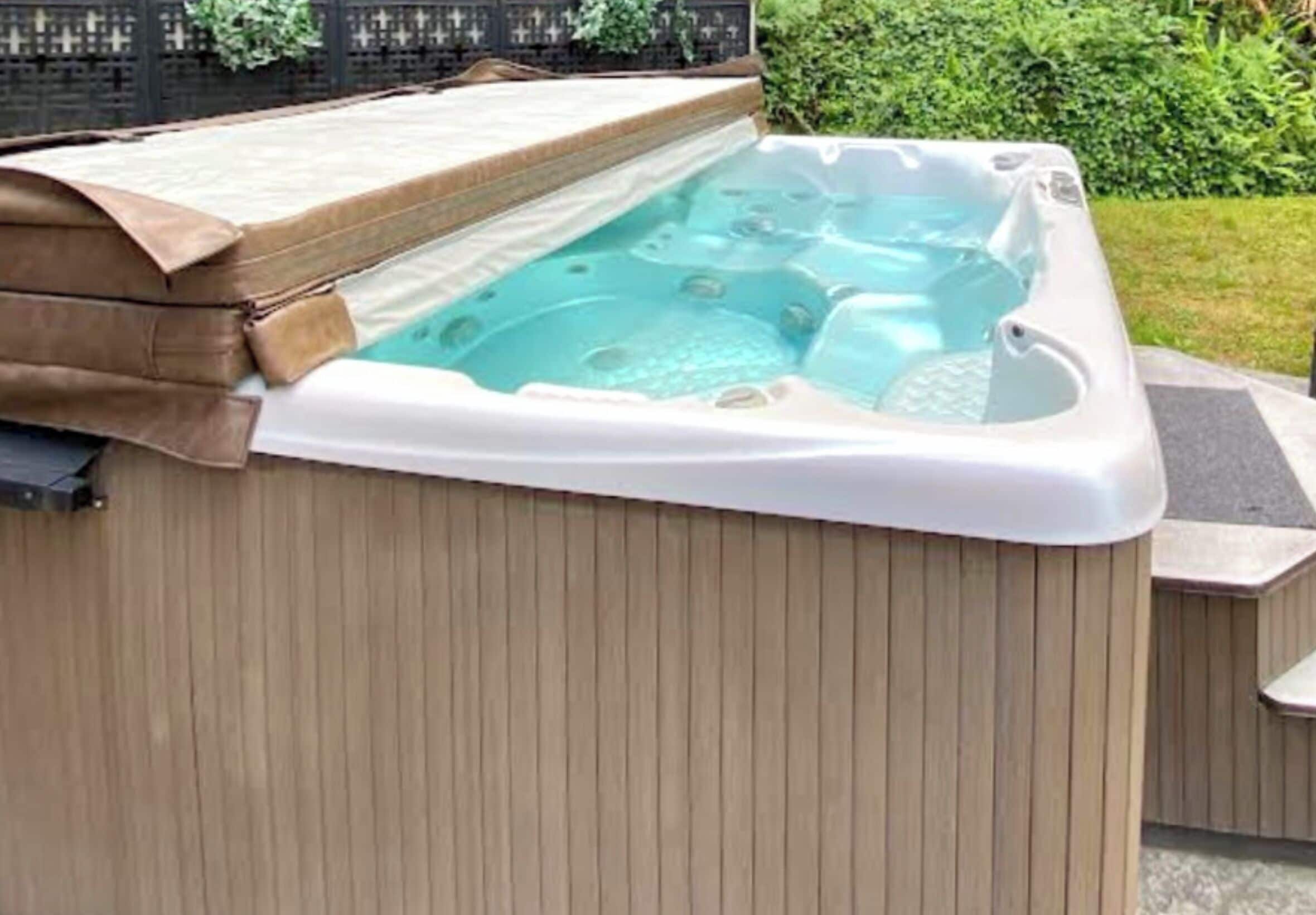 A hot tub with a wooden exterior and a cover.