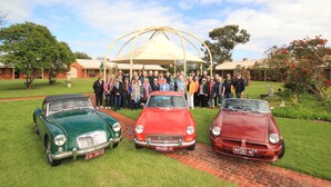 Three vintage cars parked on a grassy area with a group of people standing behind them. - Coonawarra Place Motor Inn (Coonawarra)