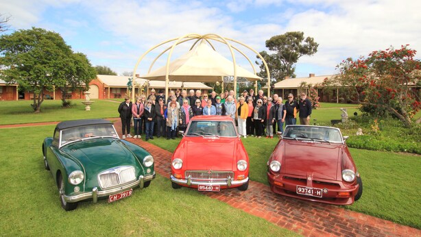 Three vintage cars parked on a grassy area with a group of people standing behind them. - Coonawarra Place Motor Inn (Coonawarra)