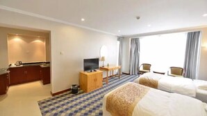 A hotel room with a checkered floor, two beds, a TV, a small table, a mirror, and a window with curtains. - Beijing RJ Brown Hotel (Beijing)