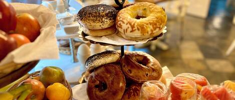 A buffet table with various pastries, fruits, and beverages.