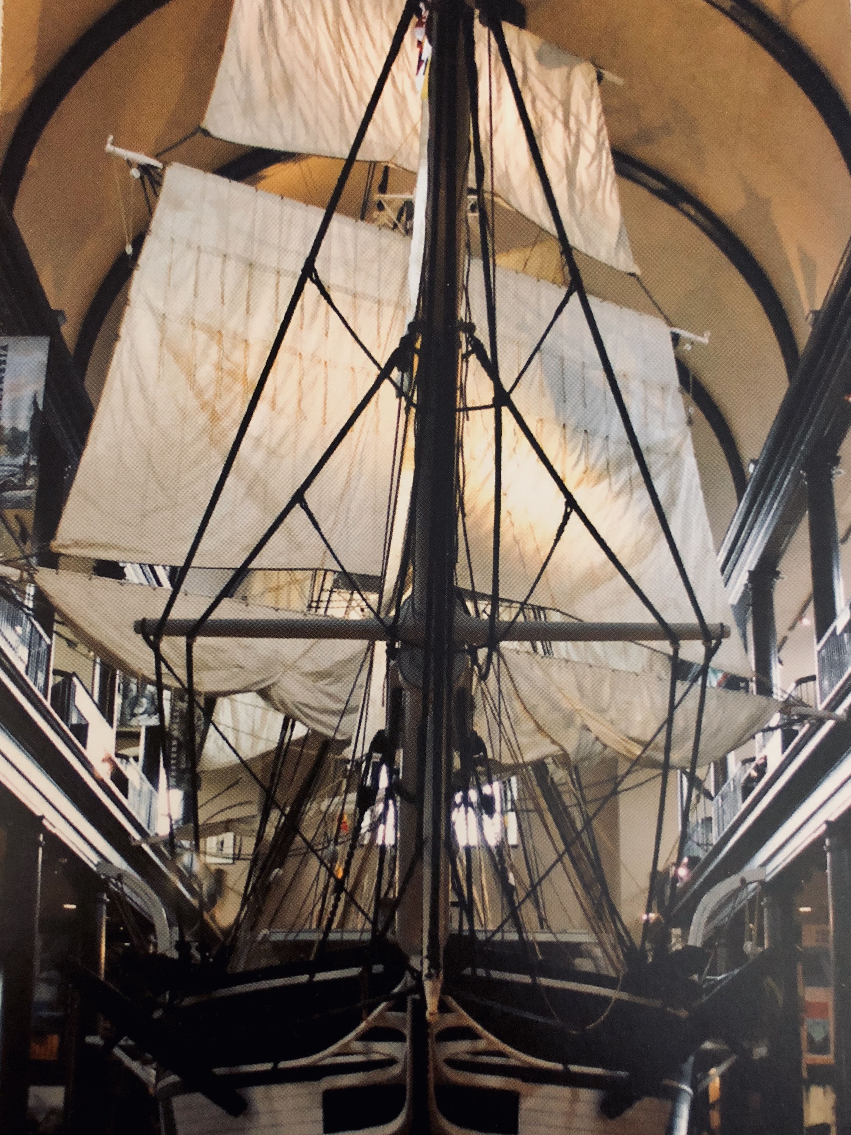 The interior of a ship with multiple decks and a large, open sail structure.