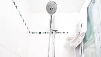 A shower with a handheld showerhead and a handheld hose.