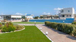 A resort with a pool, outdoor seating, and a well-maintained garden. - Sun and Moon Villas (Naxos)