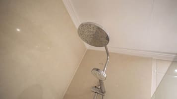 A showerhead with a circular head and a handheld attachment.