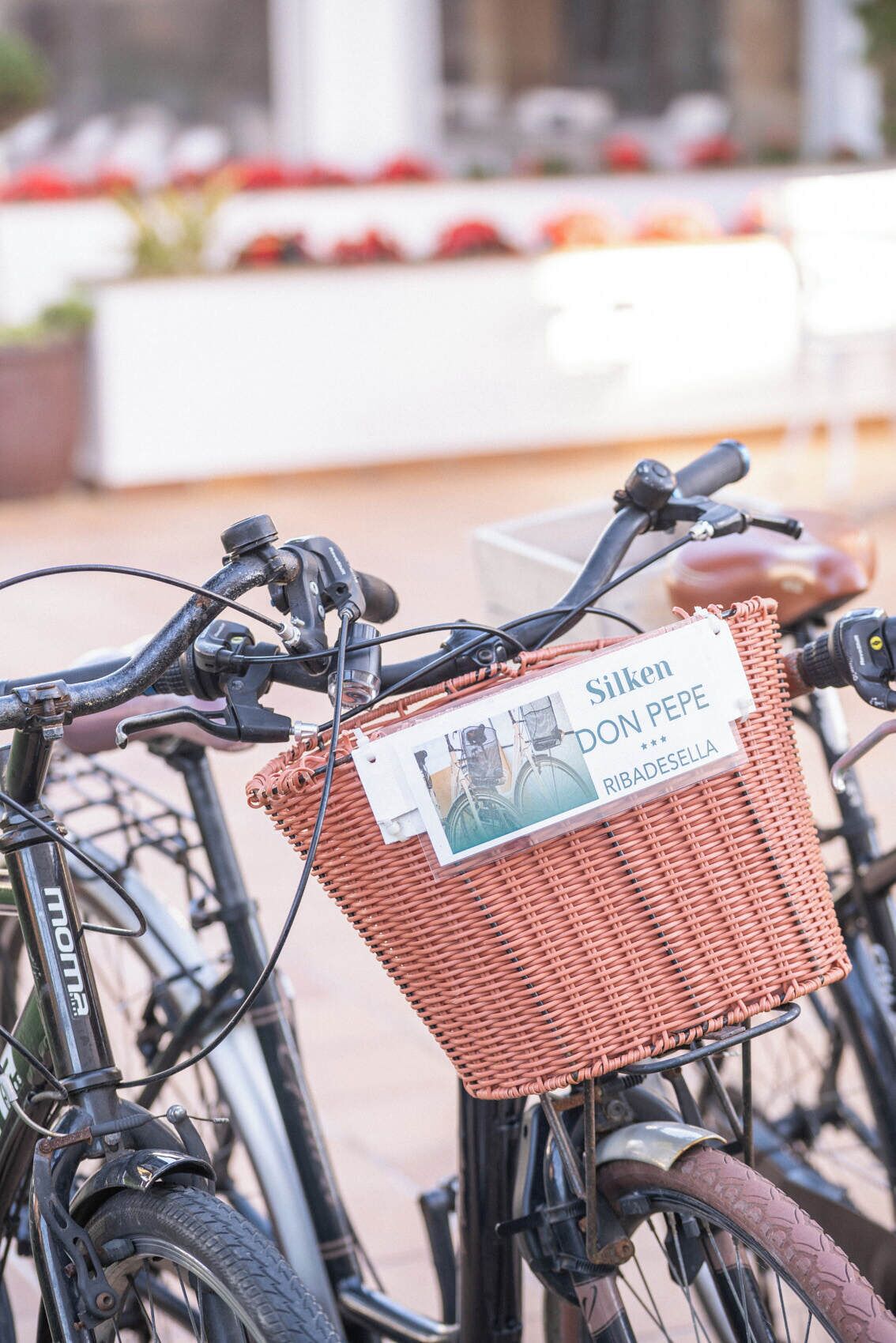 A bicycle with a wicker basket attached to the handlebars.