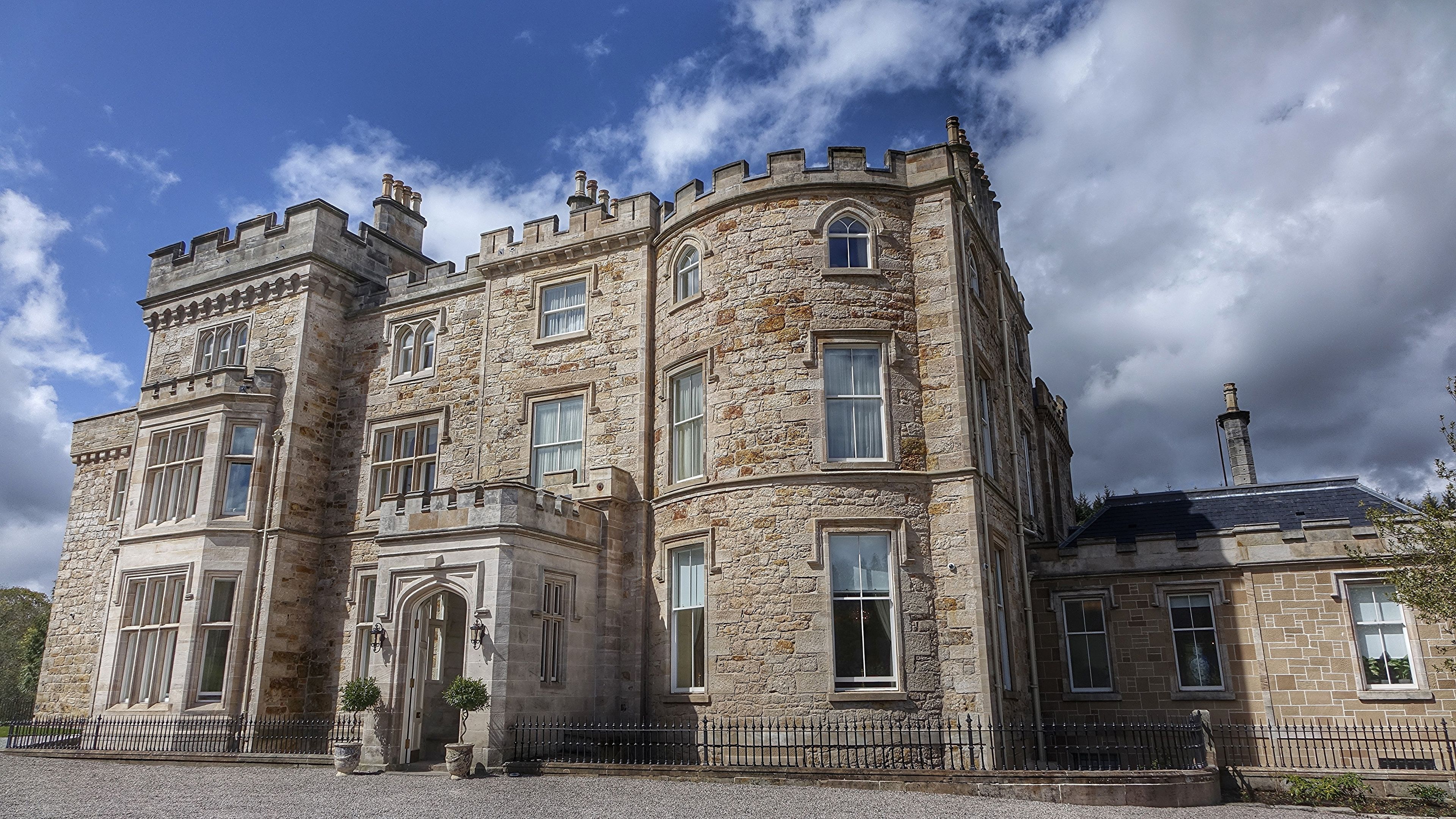 A historic stone building with multiple windows and a prominent entrance.