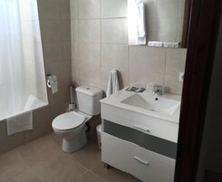 Habitación triple familiar, balcón, vistas a la ciudad | Baño | Secador de pelo, toallas y papel higiénico