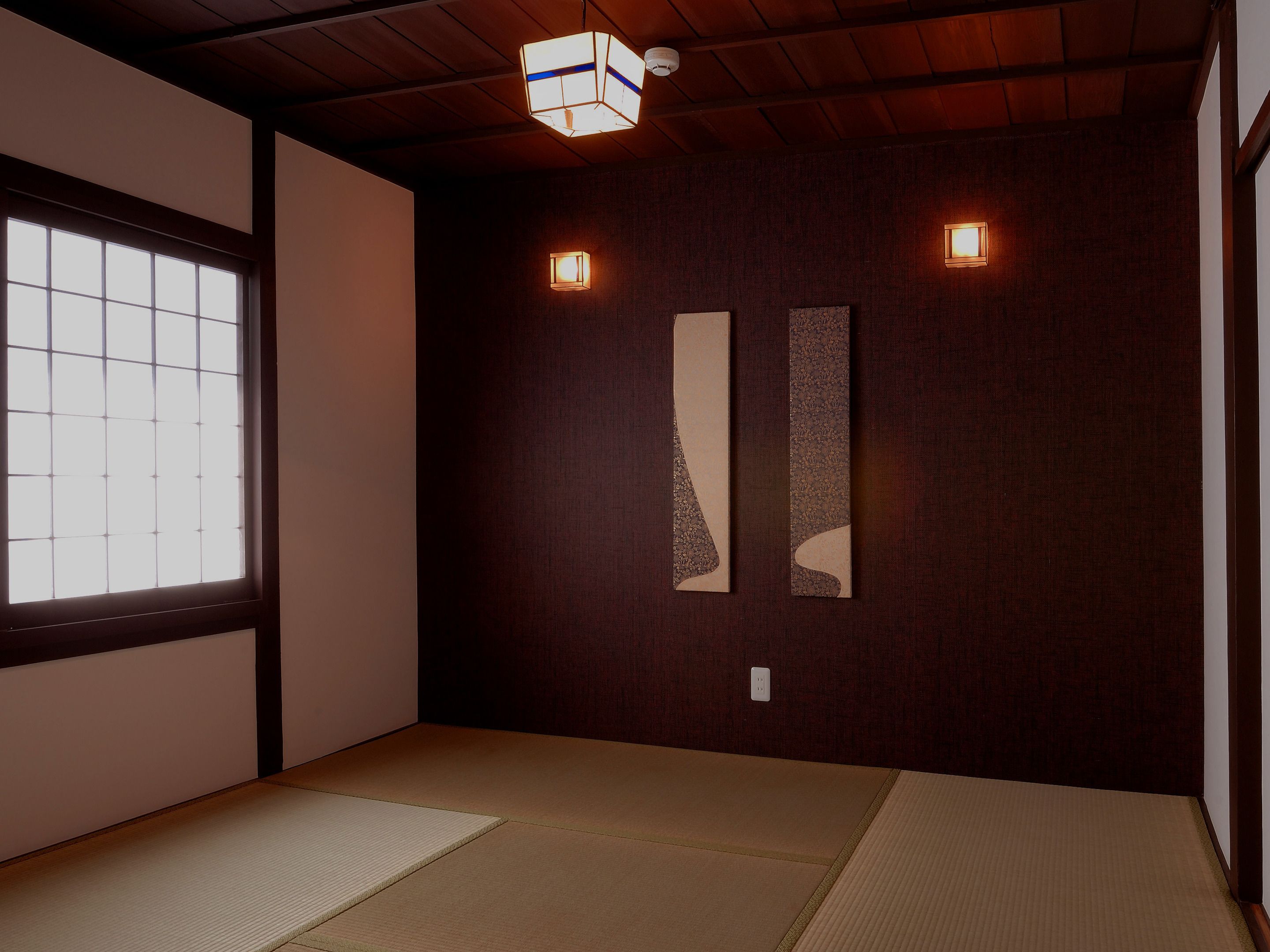 A room with tatami mats, a shoji screen, and two wall-mounted light fixtures.