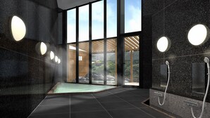 Un área de spa moderna con suelo calefaccionado, ventanas amplias y vistas al exterior.