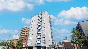 A multi-story building with a modern design, featuring balconies on each floor, and a clear blue sky in the background. - Hotel Saint Martin – Adults Only (Kyoto)